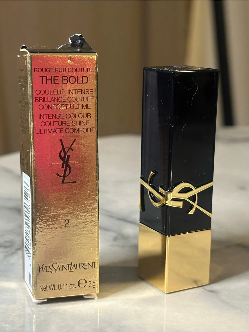 Yves Saint Laurent Gold & Black Tube Lipstick — Bright Red color “Wilful Red.”